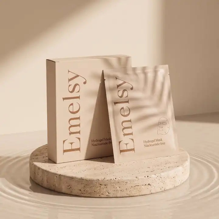 Emelsy box and sachet on a travertine pedestal in still water